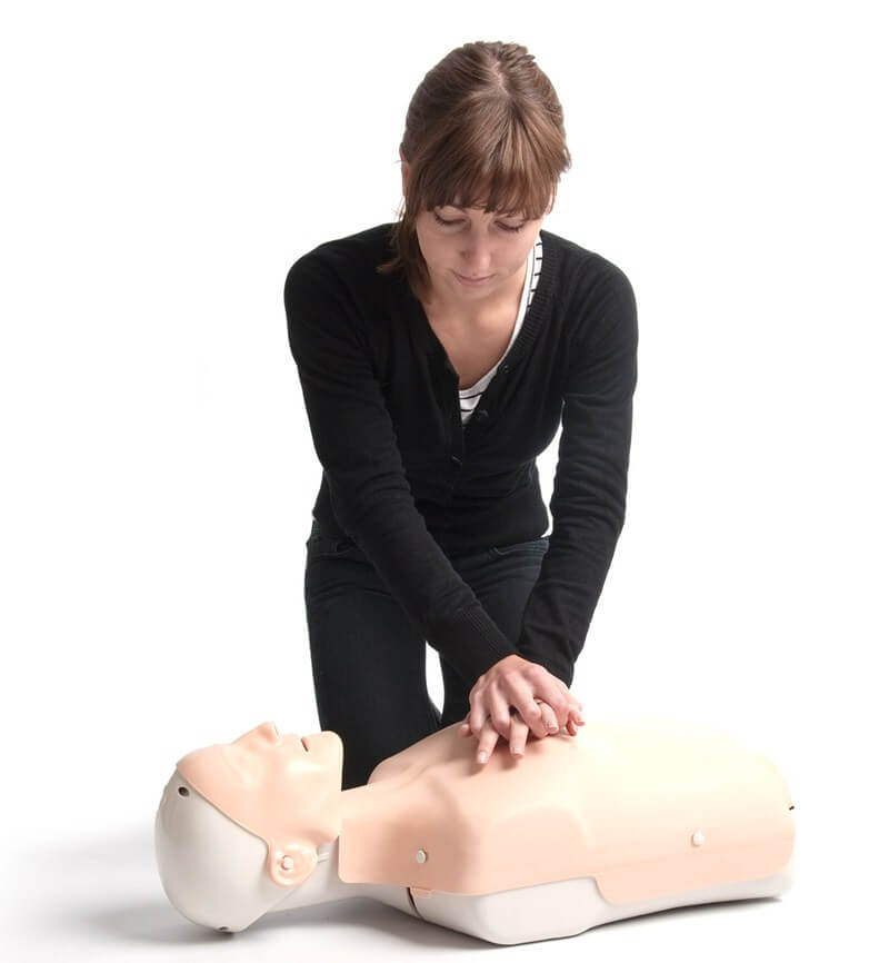 Woman performing CPR on a manikin